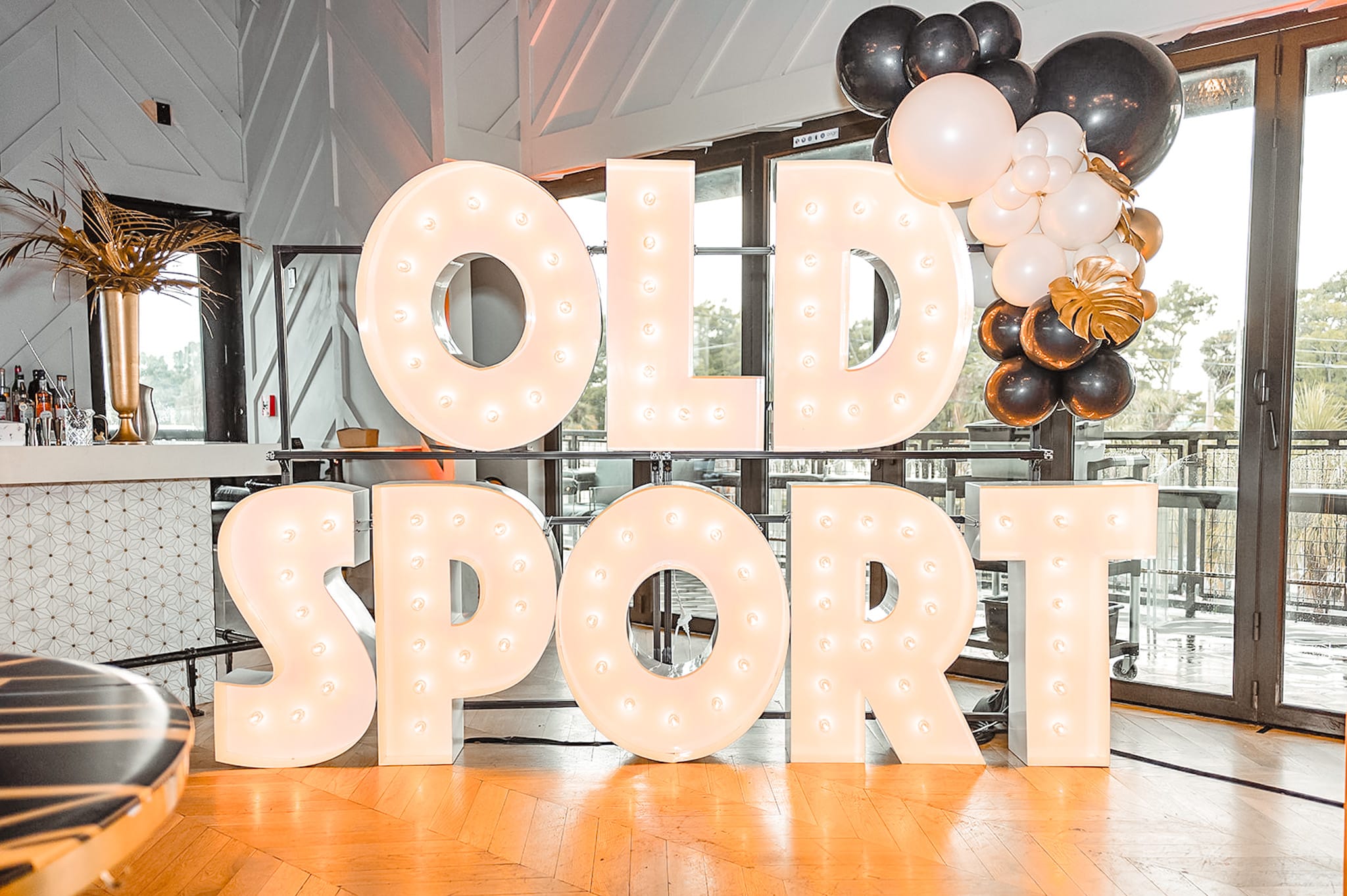A Gatsby themed party display with the marquee letters spelling out "OLD SPORT"