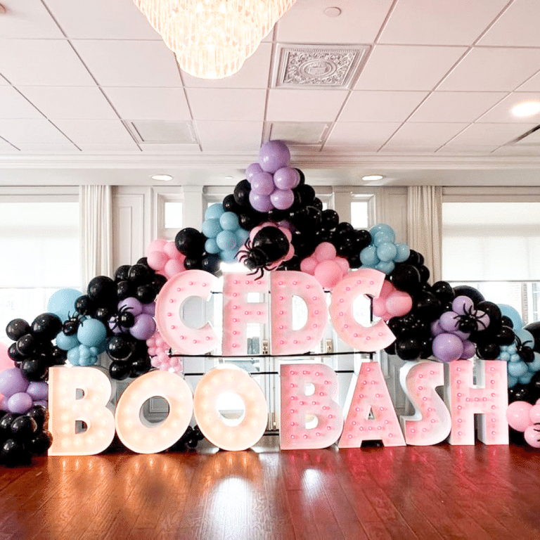 Light Up Marquee Letters that read "CFDC BOO BASH" beneath a balloon arch