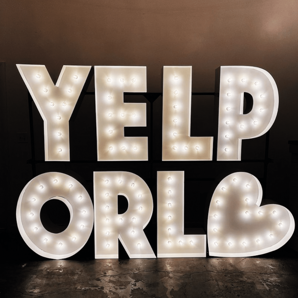Two-tier marquee letters that spell out "YELP" on the top row, "ORL" on the bottom row with a marquee heart