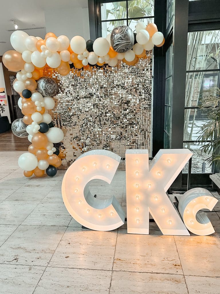 Light-Up Marquee Letters spelling out CKc with a custom small c