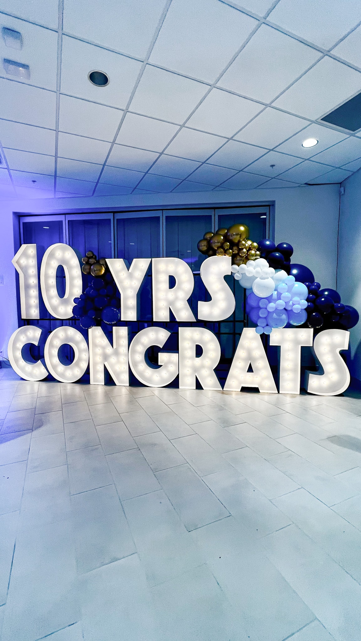 Light-Up Marquee Letters spelling out '10 YRS CONGRATS' with balloon display
