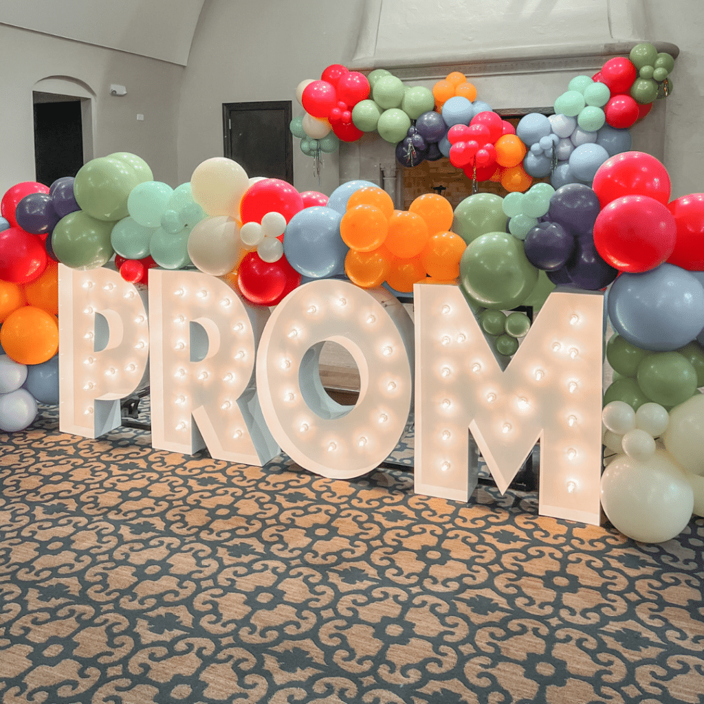 Light-Up Marquee Letters spelling out PROM with balloon display